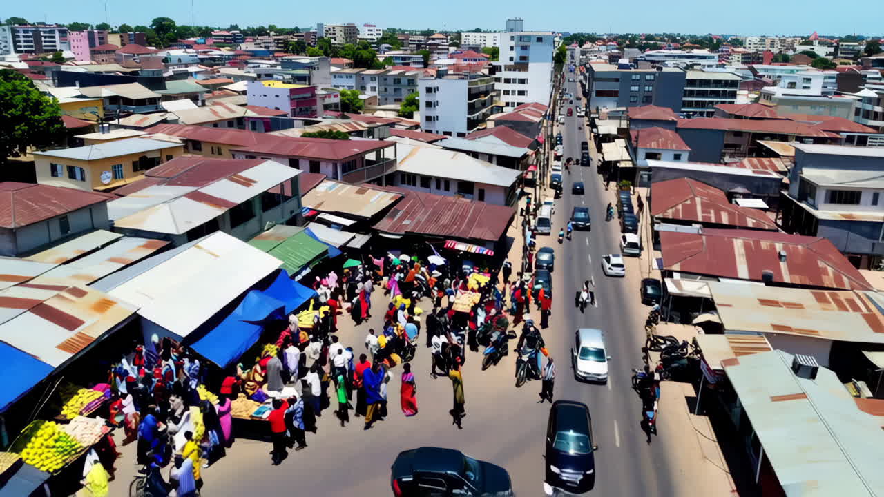 Aerial view of a bustling city street with market and traffic