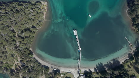 AERIAL---Beautiful-Bahia-Brava-bay-and-pier,-Villa-La-Angostura,-Neuquen,-Argentina,-top-down