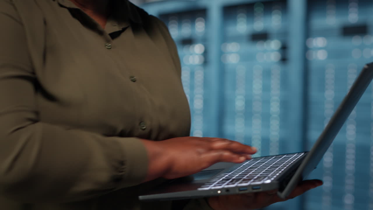 Close up of manager working in data center using laptop