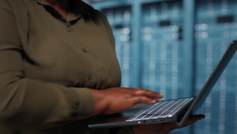 close up of manager working in data center using laptop