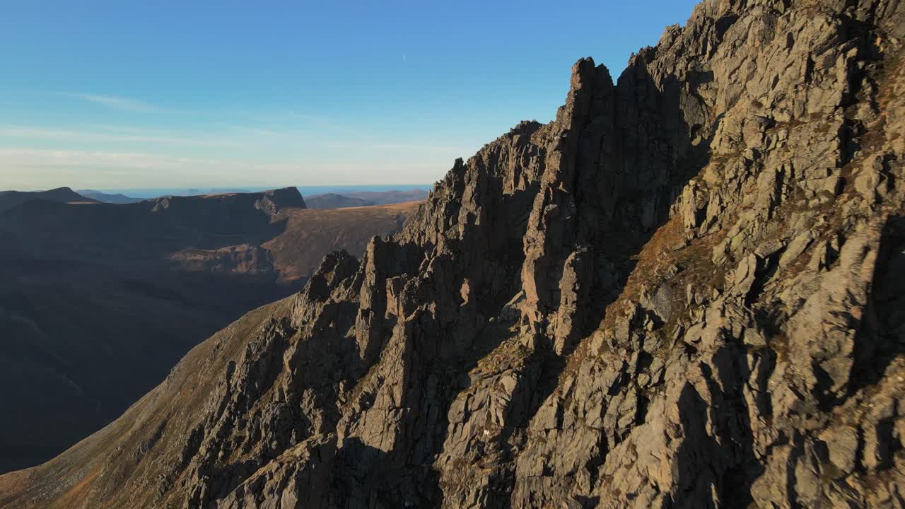 vuelo lento hacia adelante a lo largo de montañas rocosas llamadas molladalen en noruega durante el amanecer dorado