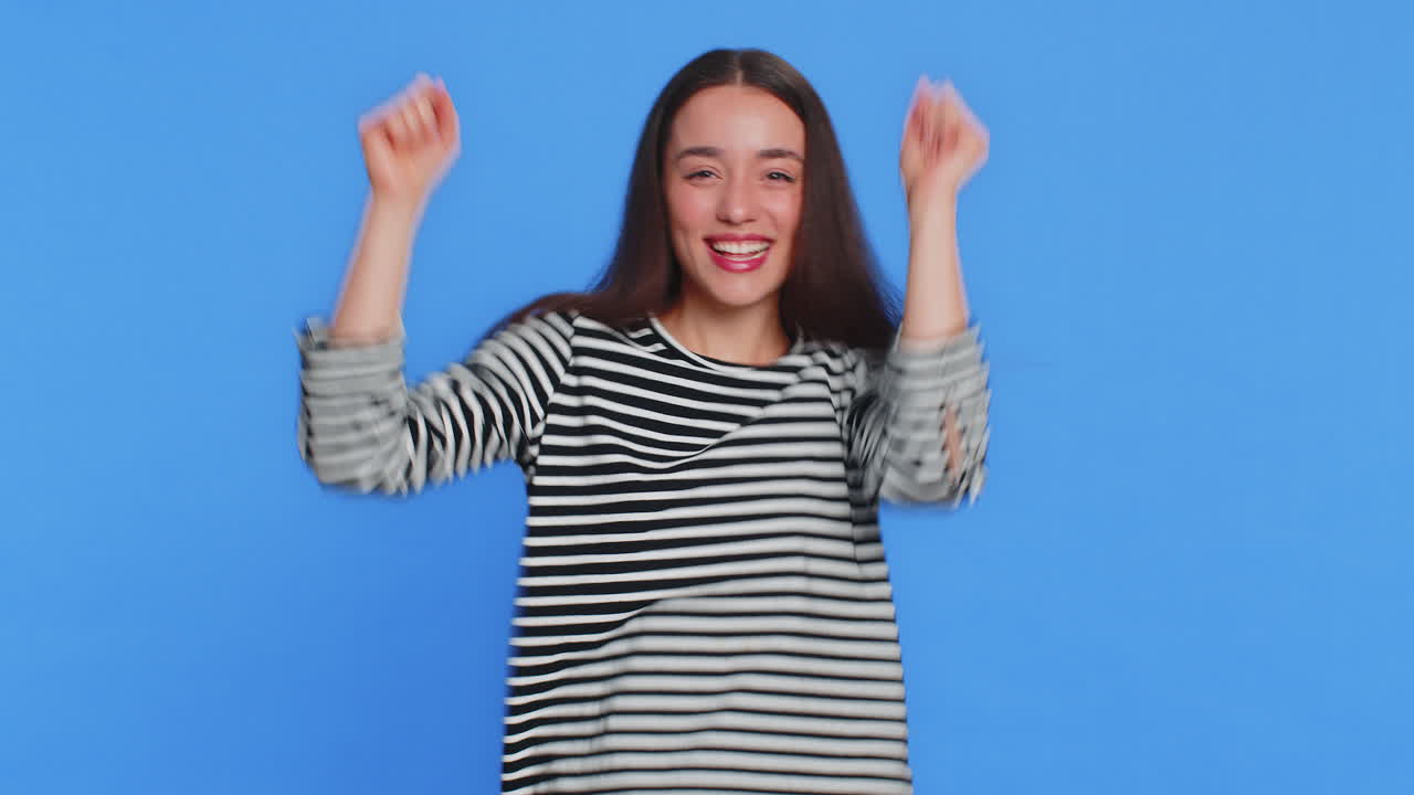 Stylish woman listening music dancing disco fooling around having fun celebrating success victory