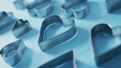 heart shape cookie cutters on blue background at valentine's day