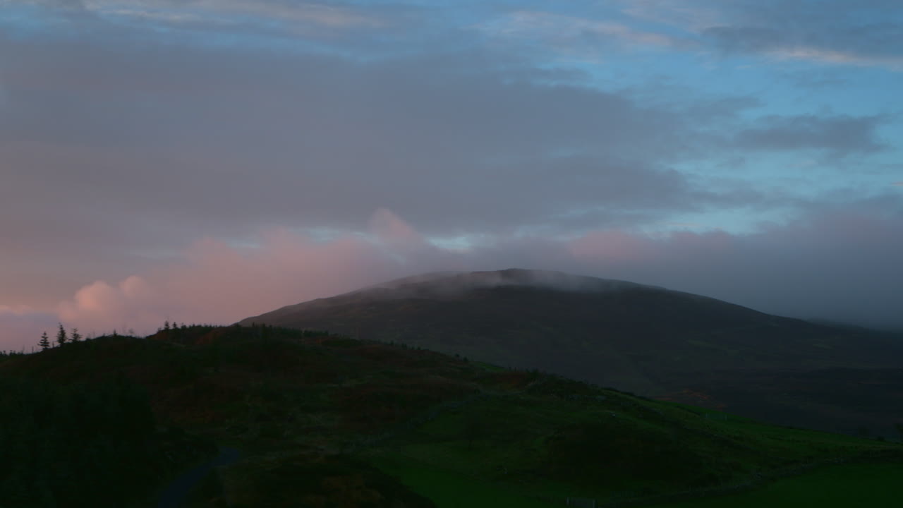 파란색과 분홍색의 해가 뜨고, 해가 지는 구름, 산과 함께