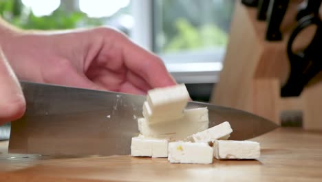 cutting feta cheese into small pieces