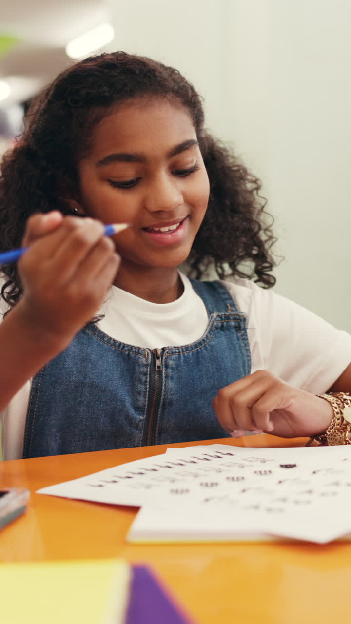 Focused Young Girl Drawing with a Pencil at a Desk