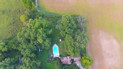 aerial view a house in the country with fields surrounding it in 4k
