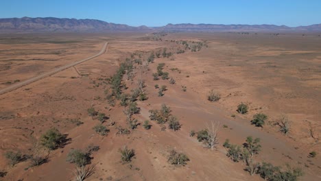 flying upwards over dried creek trail, brachina gorge, south australia outback