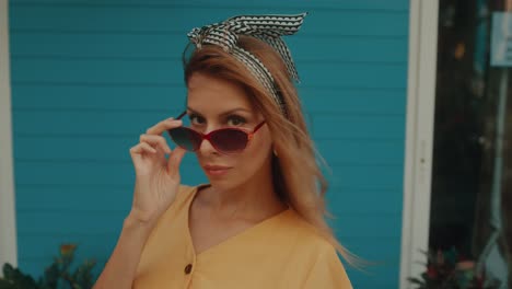 stylish woman in a yellow dress with sunglasses and headband