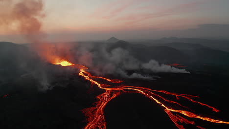 Slide-and-pan-shot-of-active-volcano-in-before-sunrise.-Panoramic-aerial-view-of-volcanic-landscape-view-glowing-hot-lava-streams.-Fagradalsfjall-volcano.-Iceland,-2021