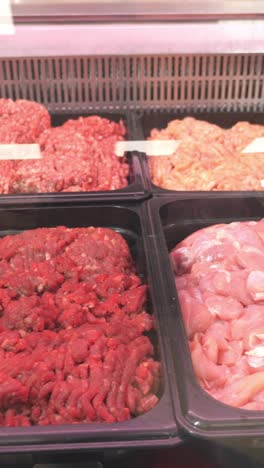 fresh ground meat displayed in a refrigerated case, showcasing various textures and colors, highlighting quality and freshness for culinary use