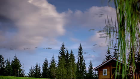 Dreamy-cloudscape-time-lapse-over-a-cabin-in-summer