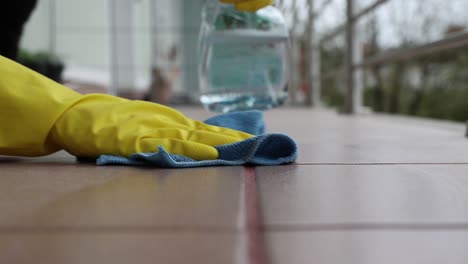 Woman-cleaning-tile-floors-outdoors,-spring-cleaning,-4k-footage,-home-cleaning