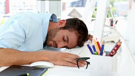 sleepy designer falling asleep at desk