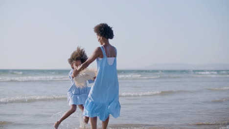 happy girl and her beautiful mum having fun at seashore