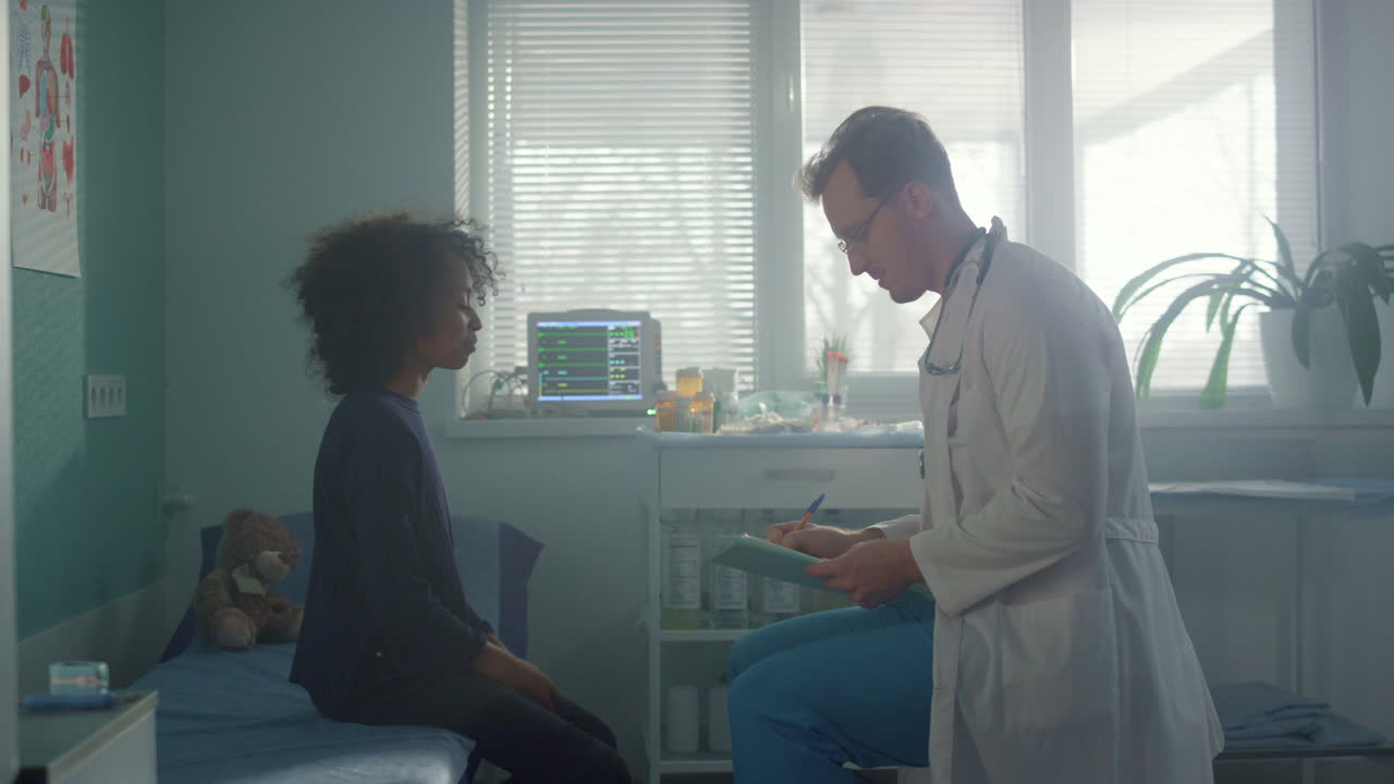 Teen girl sitting consulted with pediatrician in clinic. Child talking physician