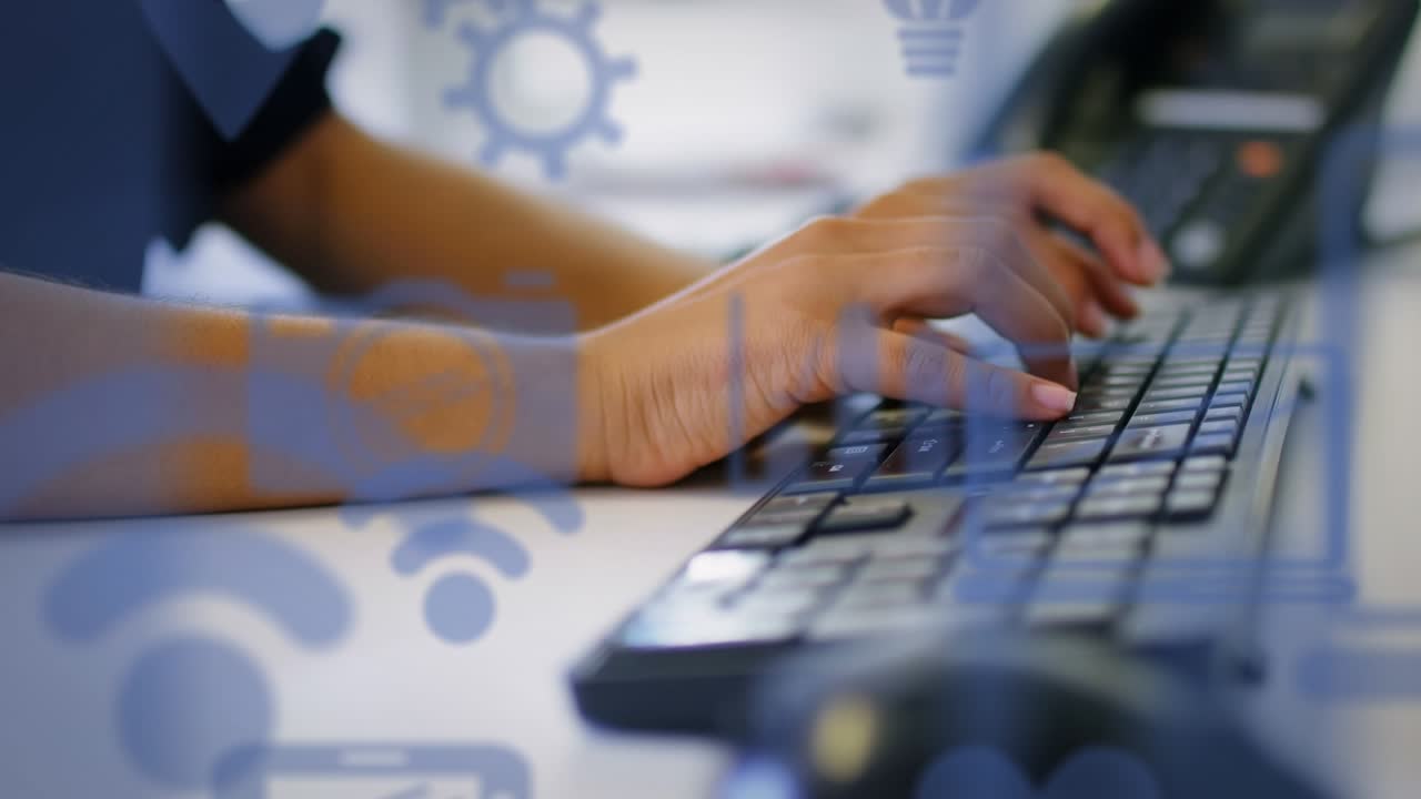 Animation of technology icons over caucasian man typing on keyboard