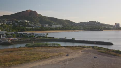 pan right, harbour and marina views at dawn on a beautiful clear morning with castle hill, townsville and the sandy still beach in the background