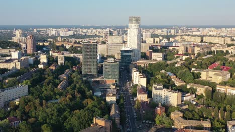 Aerial-drone-video-of-downtown-skyline-buildings-and-cars-on-the-highway-in-Pecherskyi-district-of-Kyiv-Oblast-Ukraine-during-sunset