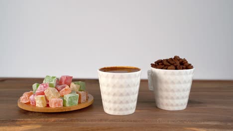 colourful turkish delight beside turkish coffee on a tabletop