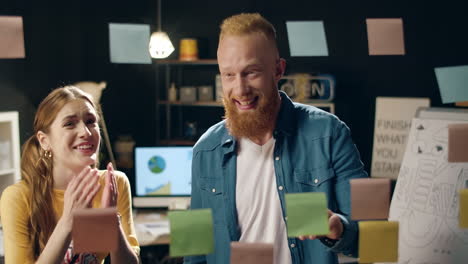 closeup joyful hipster couple looking at stickers on board