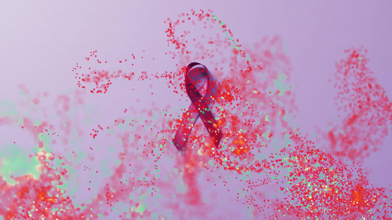 Animation of red awareness ribbon with swirling particles on purple background
