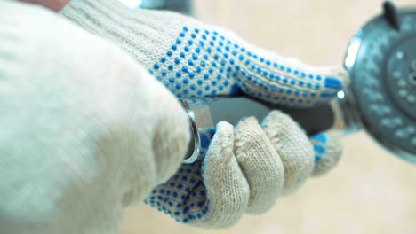 close-up gloved hands of the plumber installs the shower.