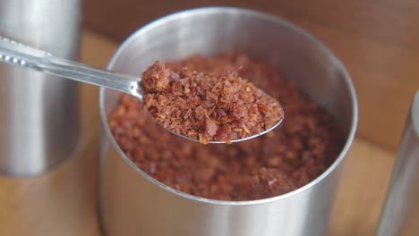 red pepper flakes in a silver jar