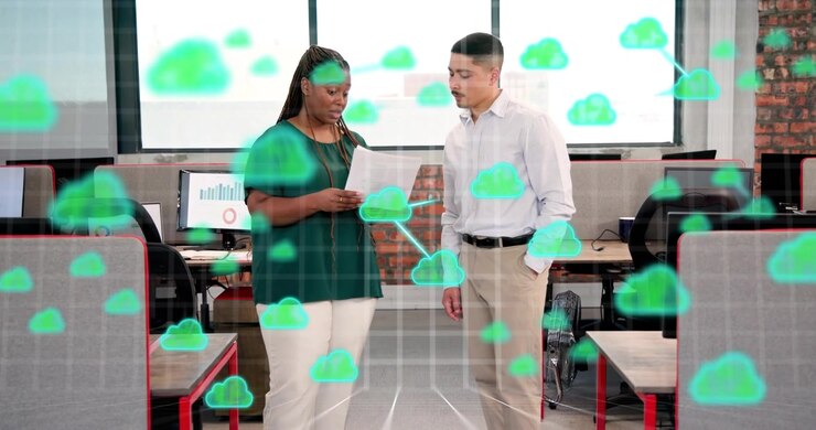 Woman explaining report to man in office, grid overlay and clouds emerging showing cloud tech