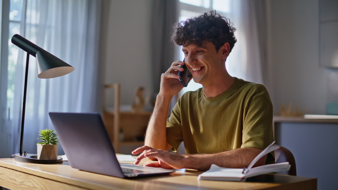 Cheerful specialist calling cellphone at home closeup. Man swiping touchpad