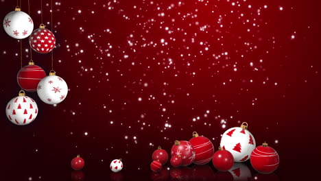 new year's christmas decorative balls on ribbons and on table with reflection. red festive background with falling snow. place for text. looped animation.