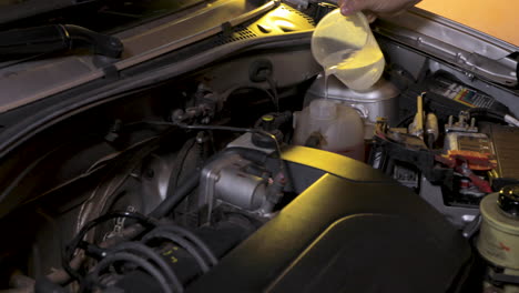 putting water in the radiator reservoir in the car engine