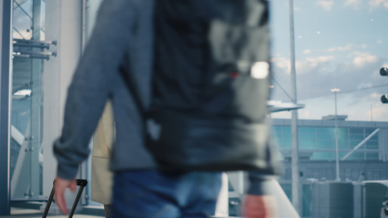 Airport Terminal: Happy Traveling Woman Walks to Her Flight Gates, Uses Smartphone, Browsing the Internet with App, Checking Traveling Destination. Female Walking Through Hallway of Airline Hub