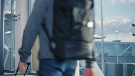 airport terminal: happy traveling woman walks to her flight gates, uses smartphone, browsing the internet with app, checking traveling destination. female walking through hallway of airline hub