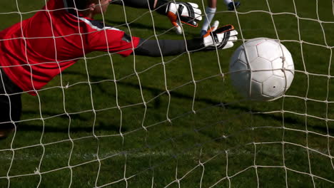 Goalkeeper-in-red-letting-in-a-goal-during-a-game