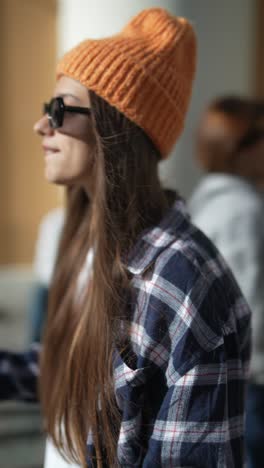 stylish woman in orange beanie and plaid shirt