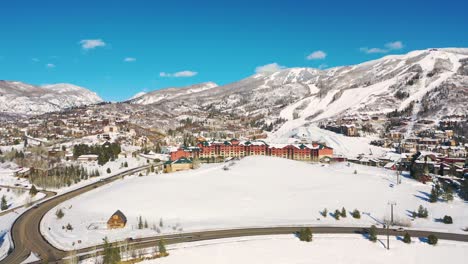 aerial view of steamboat grand resort hotel with snowy foreground in mount werner circle, steamboat springs, colorado on a sunny winter day