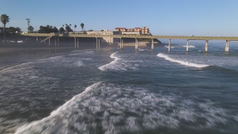 Fast-moving-drone-shot-flying-low-over-the-waves-in-San-Diego-California