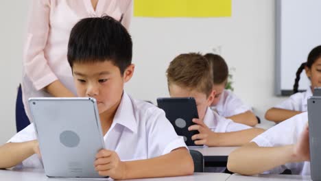 schoolkids using digital tablet in classroom