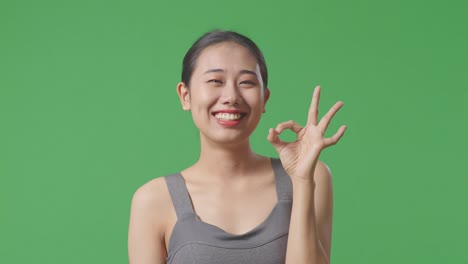 smiling woman making ok sign