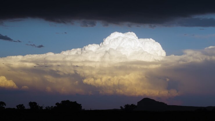 White Storm Clouds Bubble Up In Bright Sun Set Colours