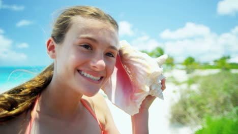 portrait of teenager on beach with conch shell