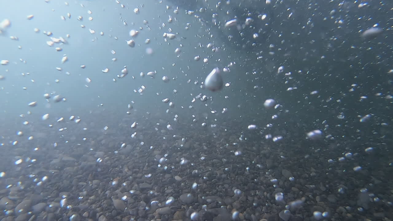 Tech scuba divers use scooters in high current turbulent river dive