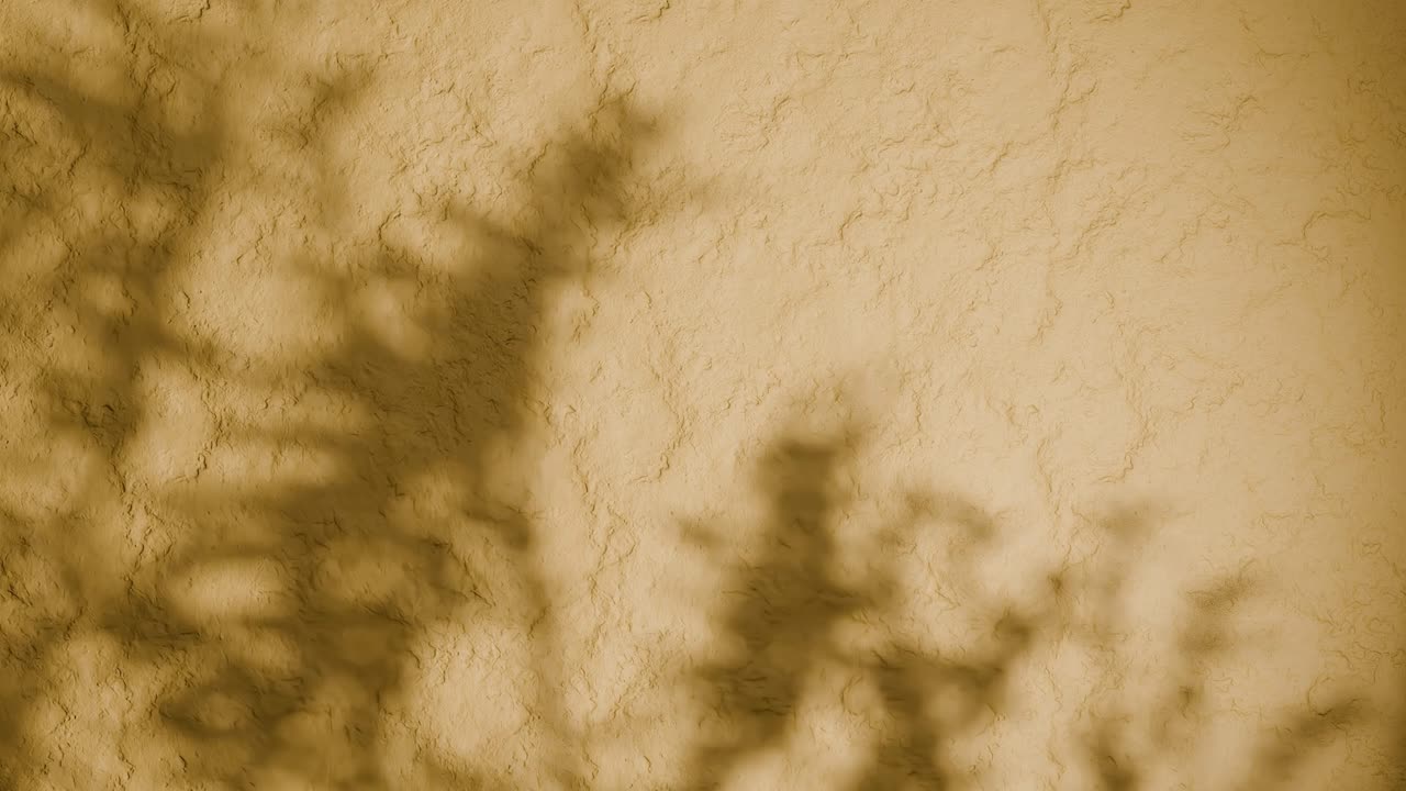 Shadow of plant branches on textured yellow plaster wall. Minimal nature-inspired background with soft natural light and rough stucco surface. Design for wallpaper, banner, vertical