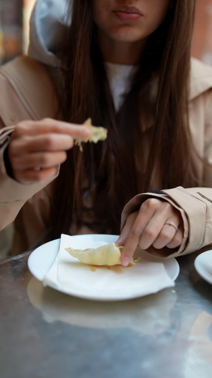 Woman eating pastry in a cafe