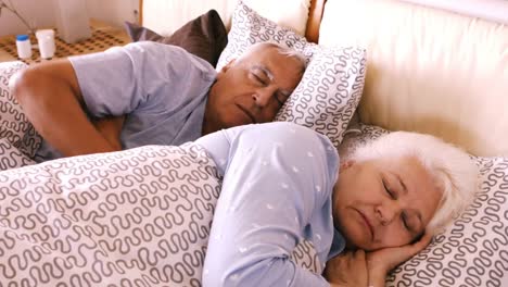 Senior-man-embracing-senior-woman-while-sleeping