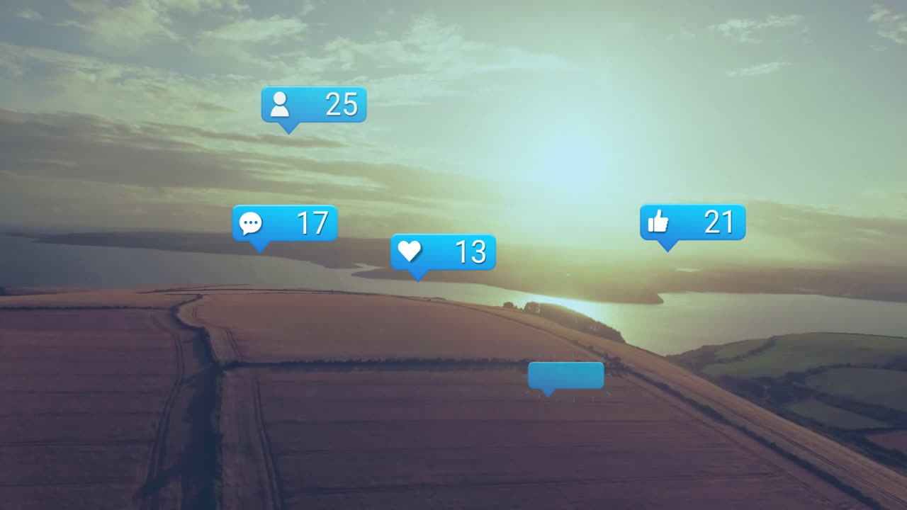 Floating flat social media icons showing user comment like counts over aerial farmland by water