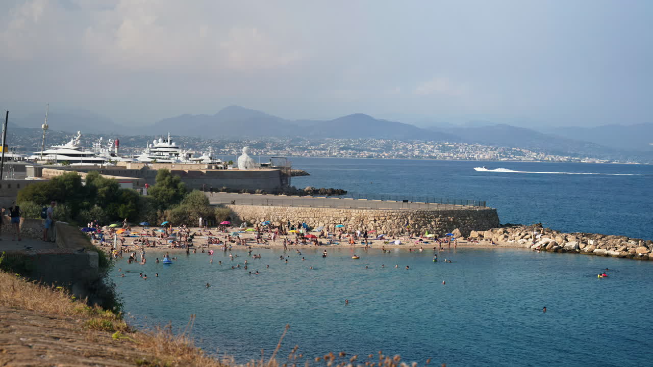People swimming in the sea and relaxing on the beach in Antibes, France