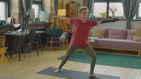girl with prosthetic arm practicing yoga at home