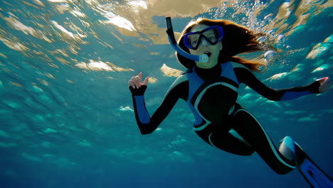 woman snorkeling underwater with bubbles